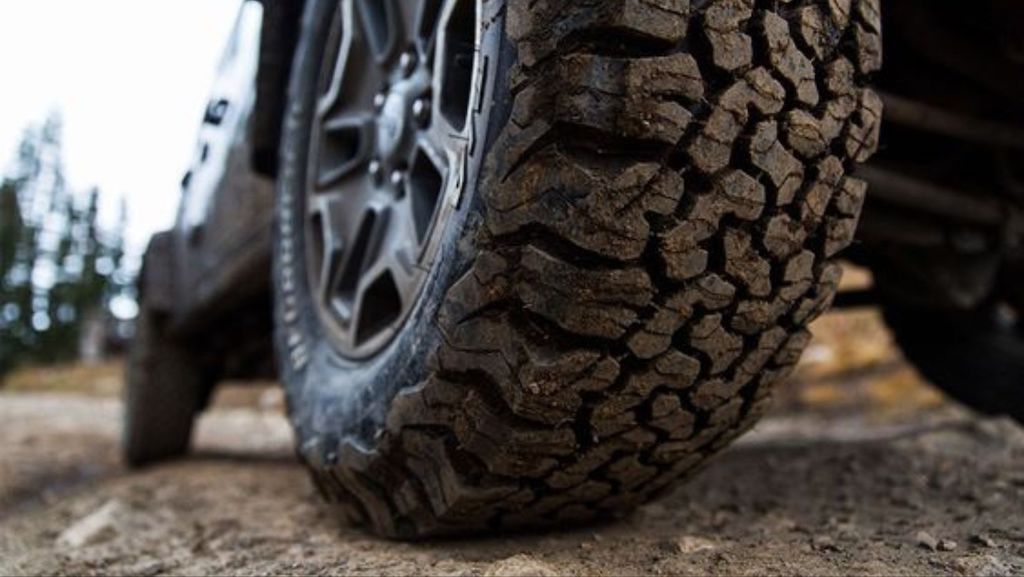 All Terrain Tyre driving over dirt road. 