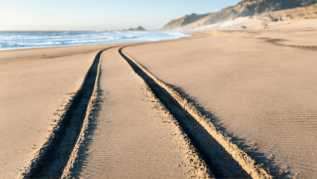 4x4 driving tracks in sand on beach