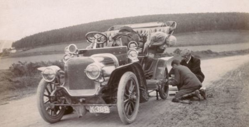 Vintage photograph of changing a flat tyre