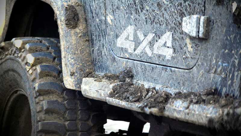 Mud tyres and car marked with 4X4 sticker